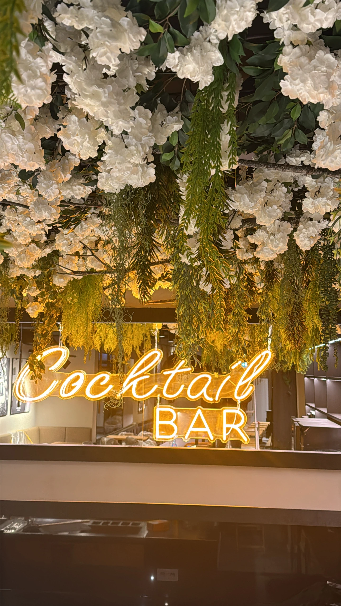 Neu gestaltete Cocktailbar im Capablanca Siegburg mit Pflanzen, Blumen und beleuchtetem Bar Schriftzug